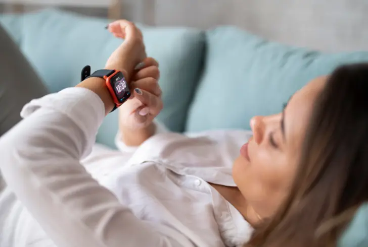 Person checking sleep stats on smartwatch